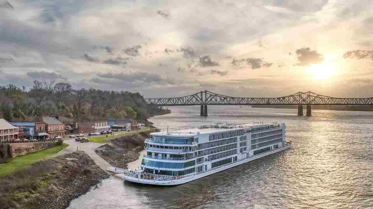 The Mississippi River cruise ship is docked in front of a bridge