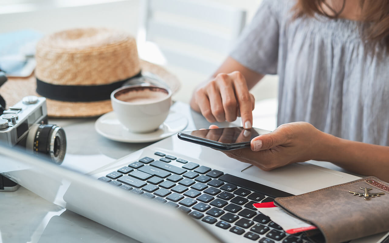 Woman booking travel plans on her phone