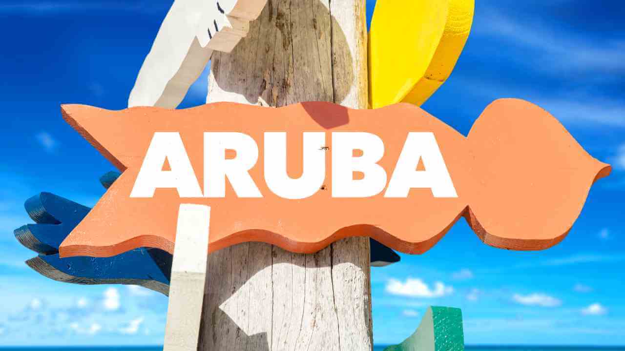 a wooden sign with the word aruba on it
