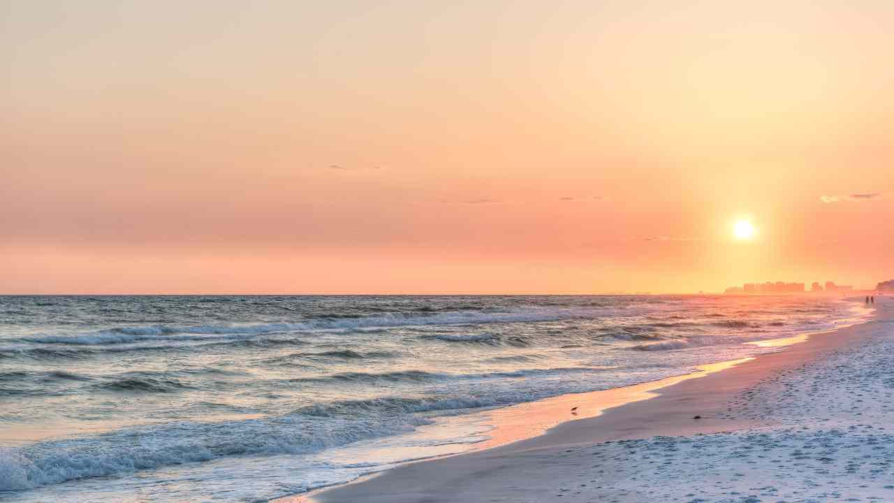 the sun rises over the beach at sunset in panama city beach, florida