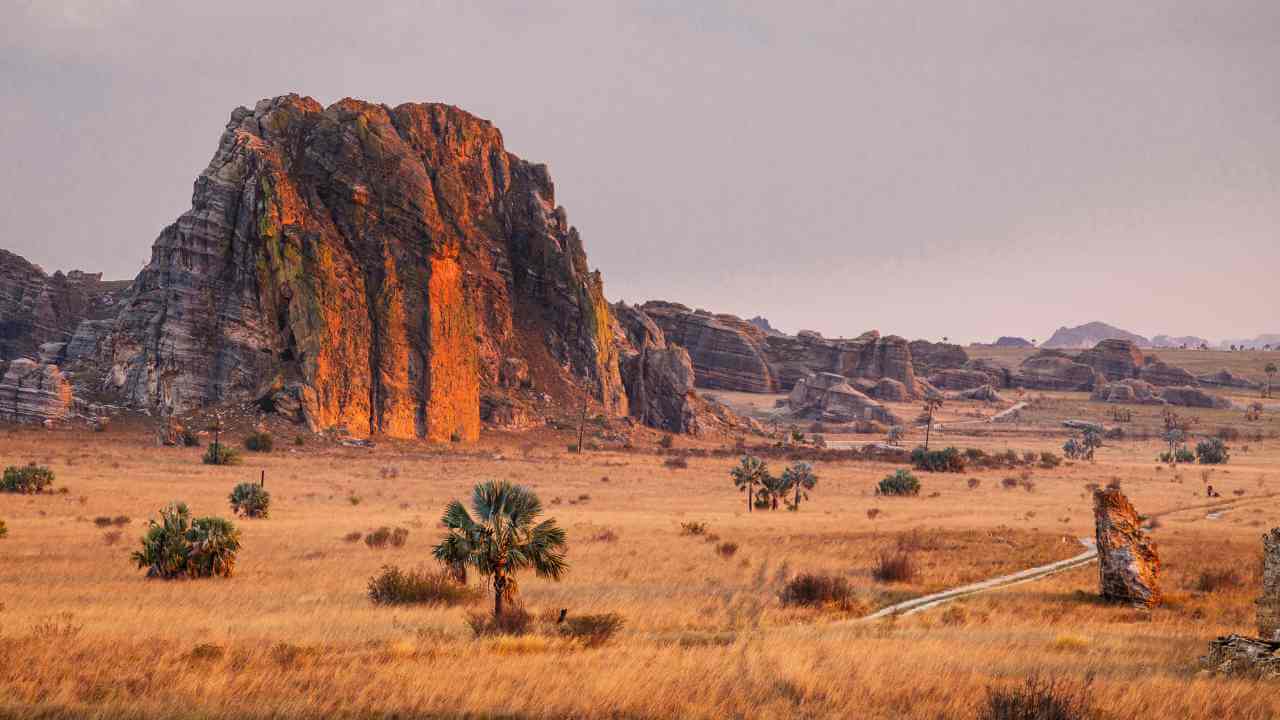 a large rock formation in the middle of an open field