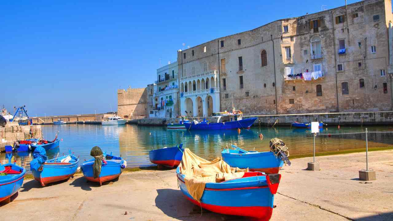 several boats are docked in front of an old building