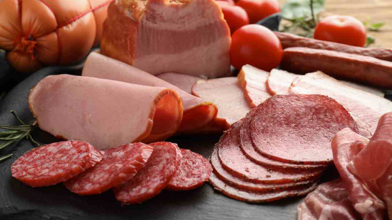 sliced meat and vegetables on a cutting board