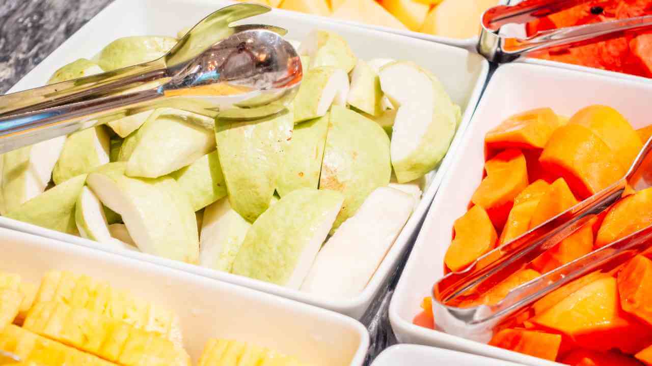 various types of fruit and vegetables are displayed in bowls