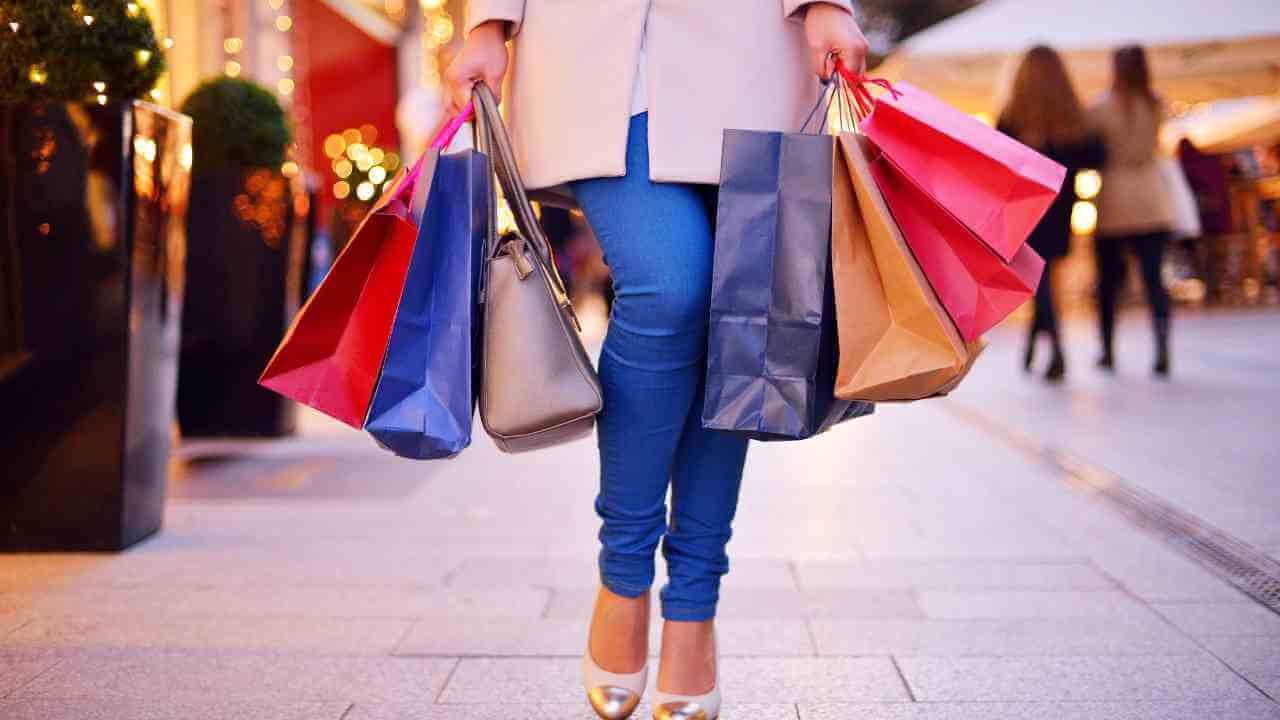 a person walking down the street with shopping bags