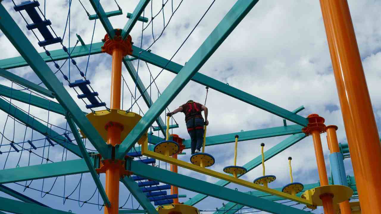 a person on a zip line at an amusement park