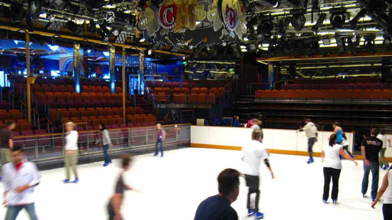 a group of people skating on an ice rink