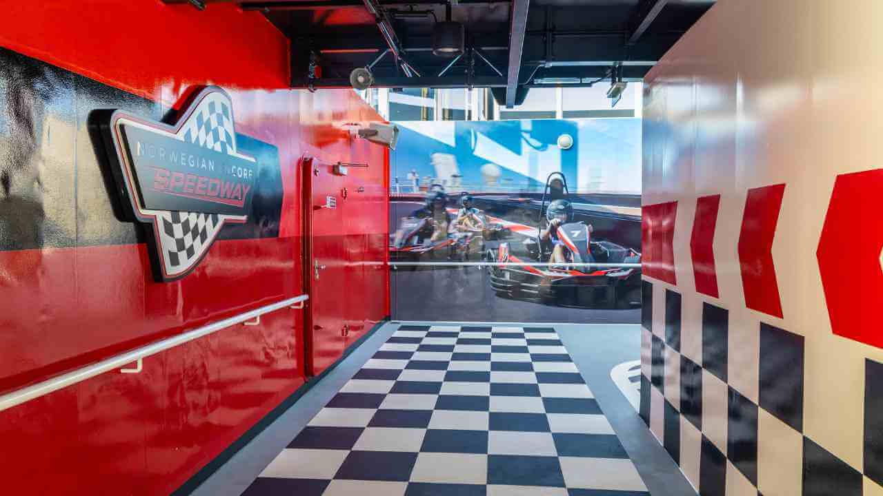 a hallway with a checkered floor and red walls