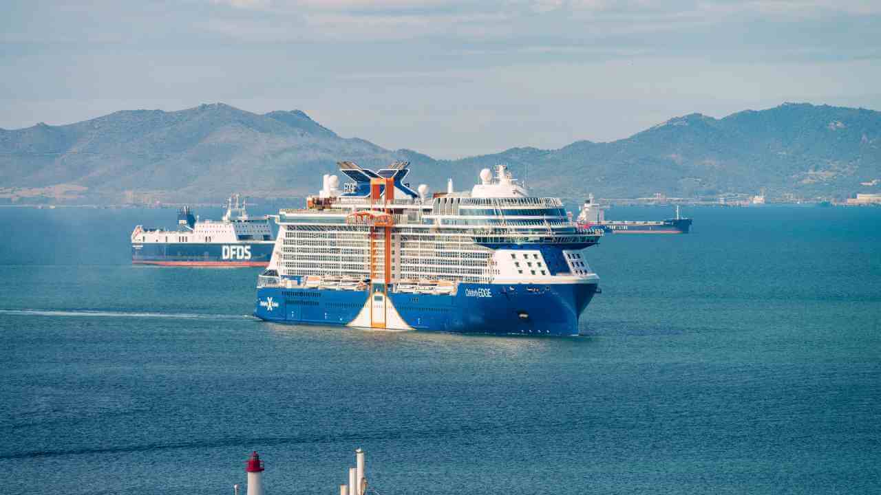 a large blue and white cruise ship in the ocean