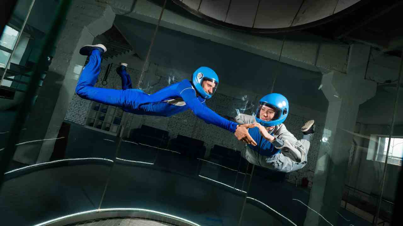 two people in blue suits flying through the air