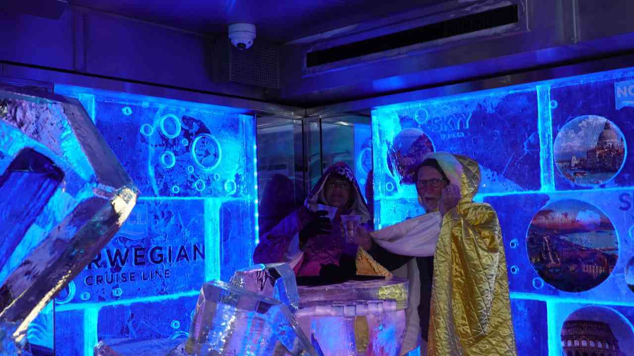 two people are standing in front of an ice sculpture