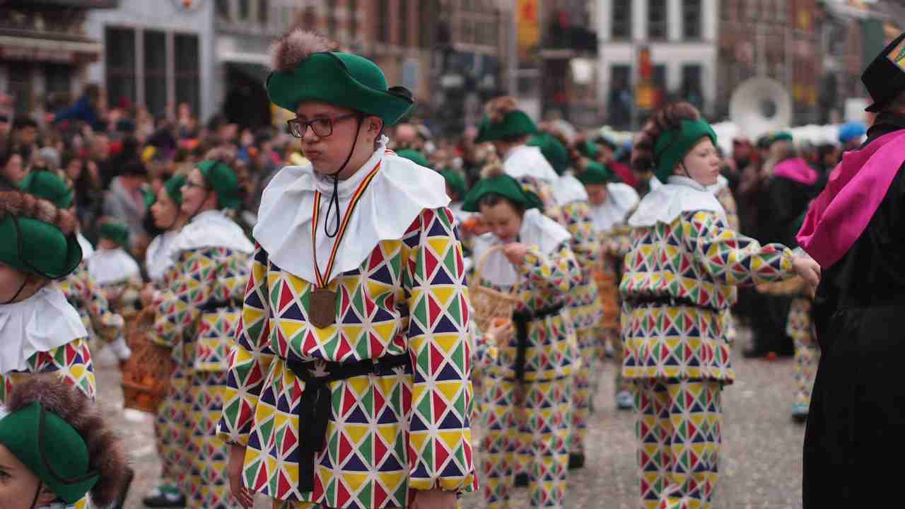 a group of people dressed in colorful costumes on the street