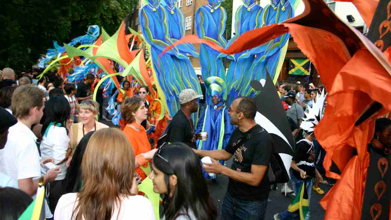 a group of people walking down the street with colorful costumes