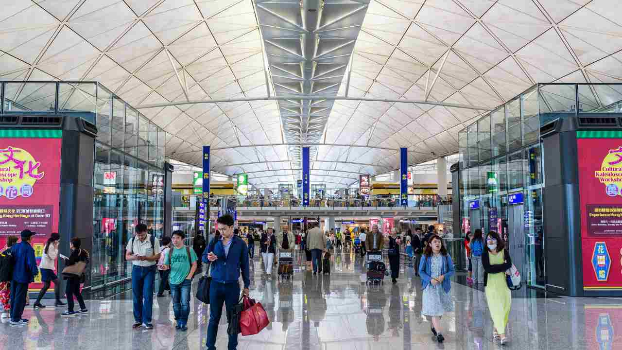 many people walk through an airport terminal