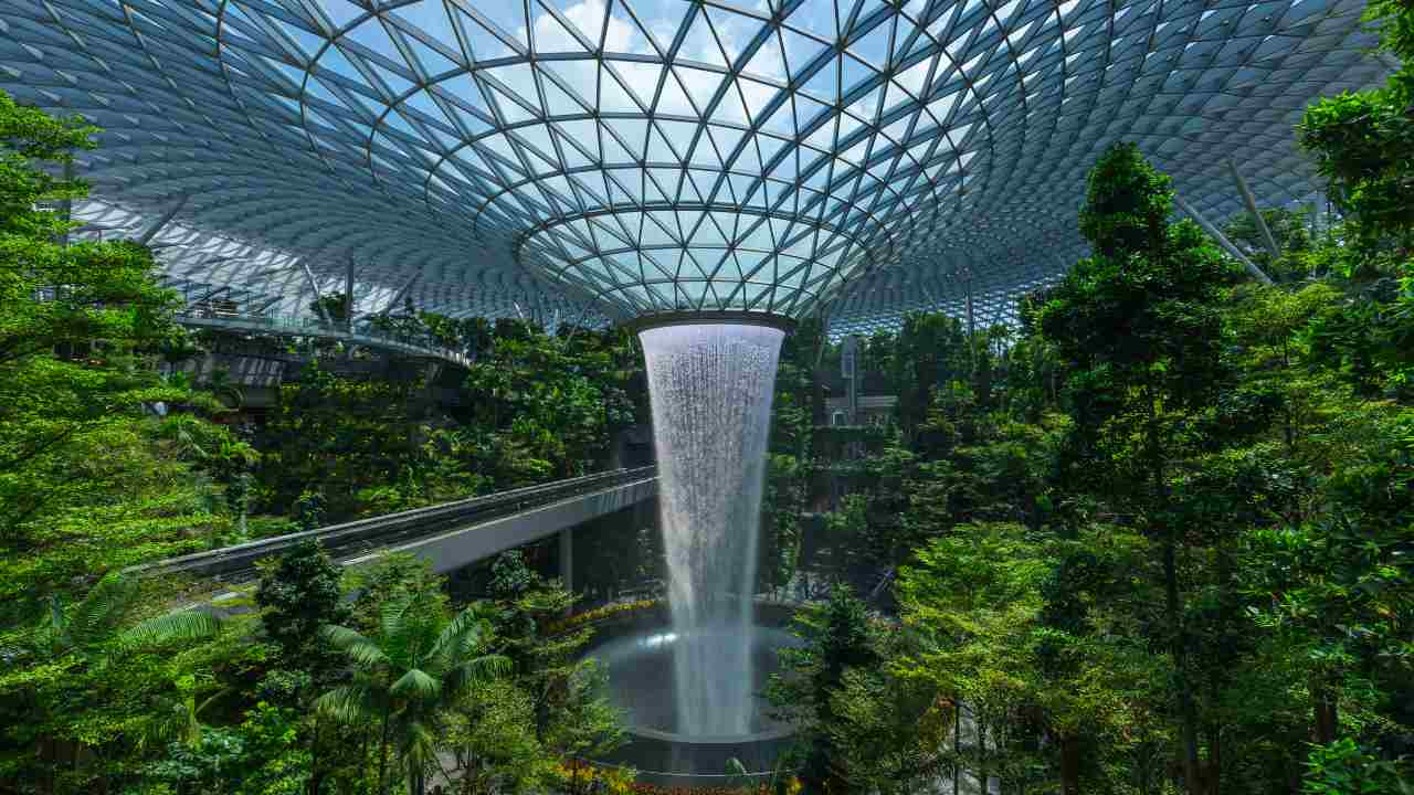 an indoor waterfall in the middle of a forest