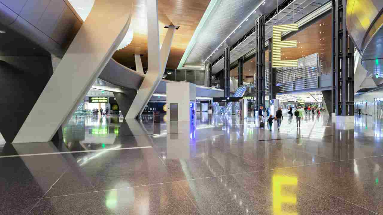 the inside of an airport with people walking around