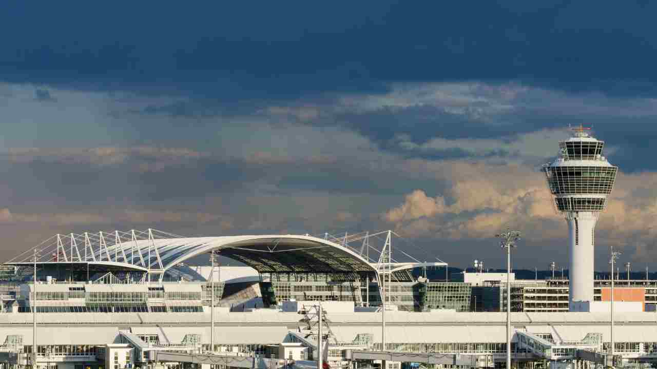 an airport with an air traffic control tower in the background