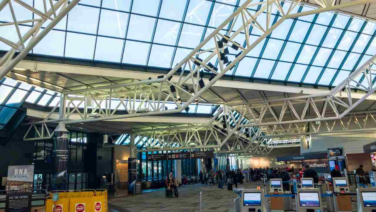 the inside of an airport terminal with people walking around