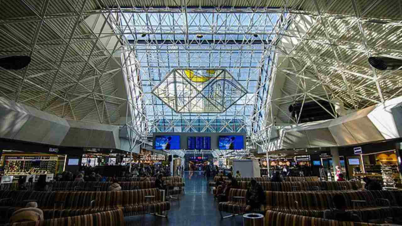 the interior of an airport with a large glass ceiling