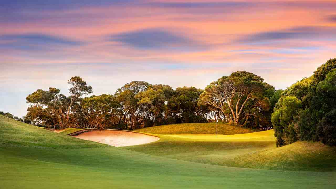 a beautiful golf course at sunset in australia