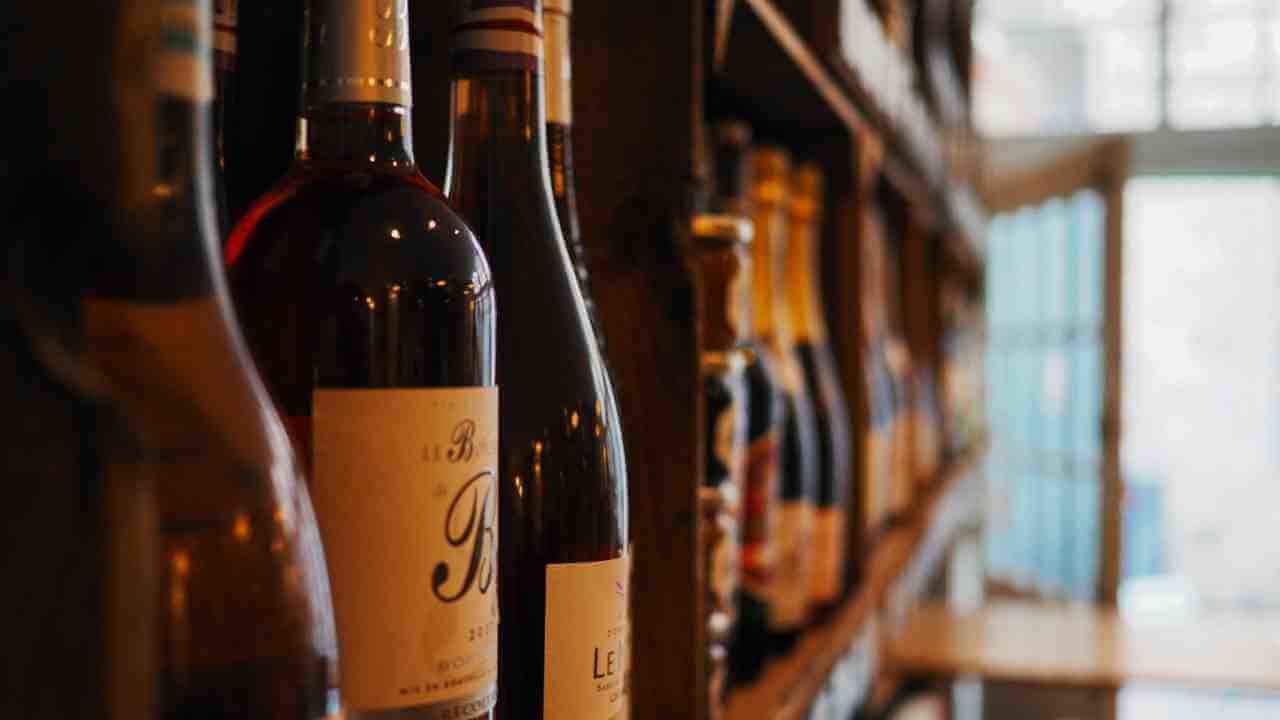 bottles of wine are lined up on a shelf