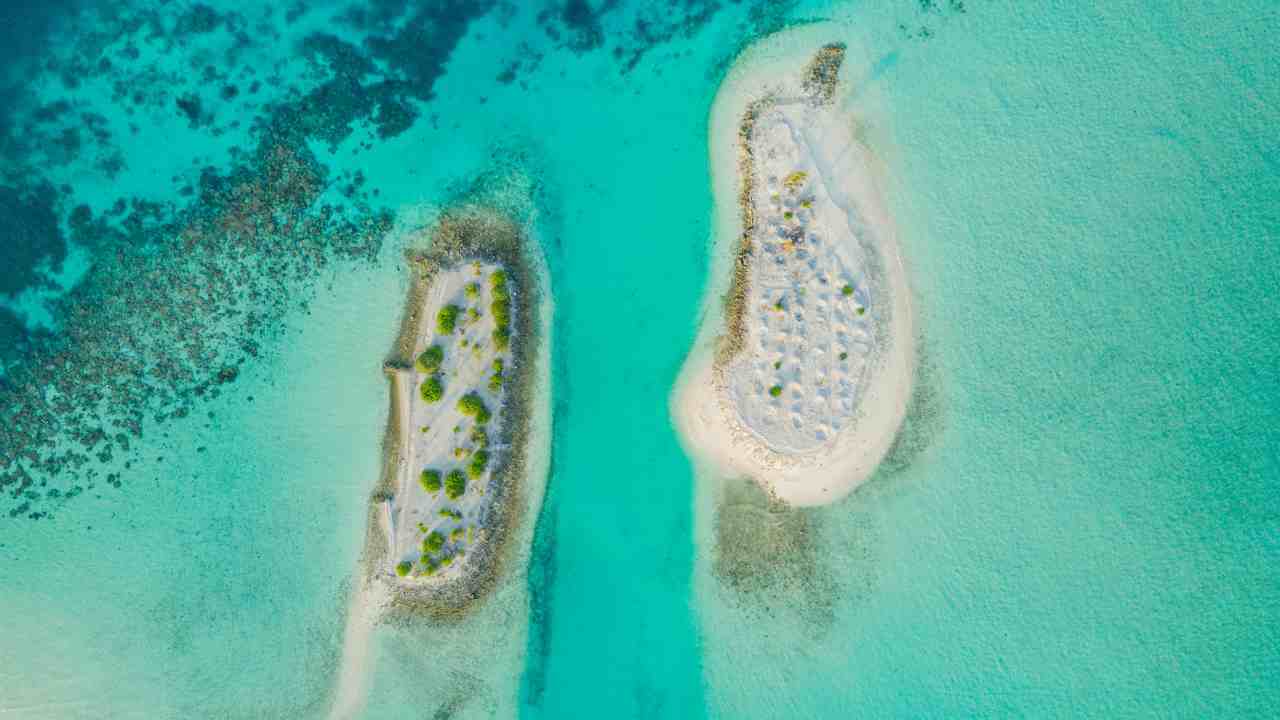 an aerial view of two small islands in the middle of the ocean