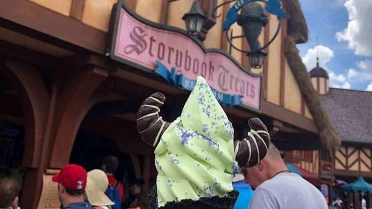 a person wearing a green and white ice cream cone on their head