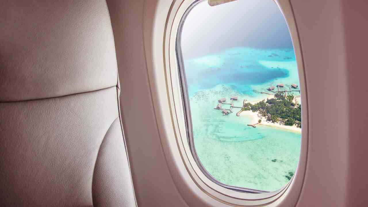 airplane window view of tropical island - window view stock videos & royalty-free footage