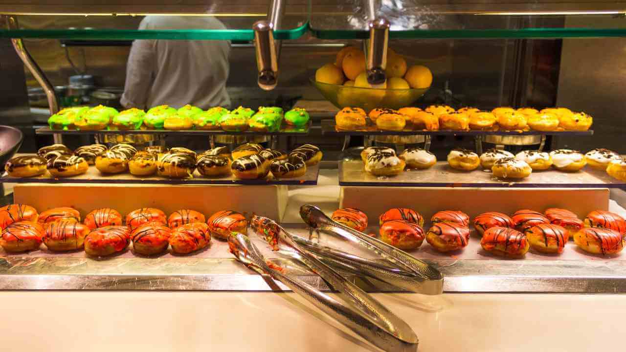 various types of pastries are displayed in a buffet