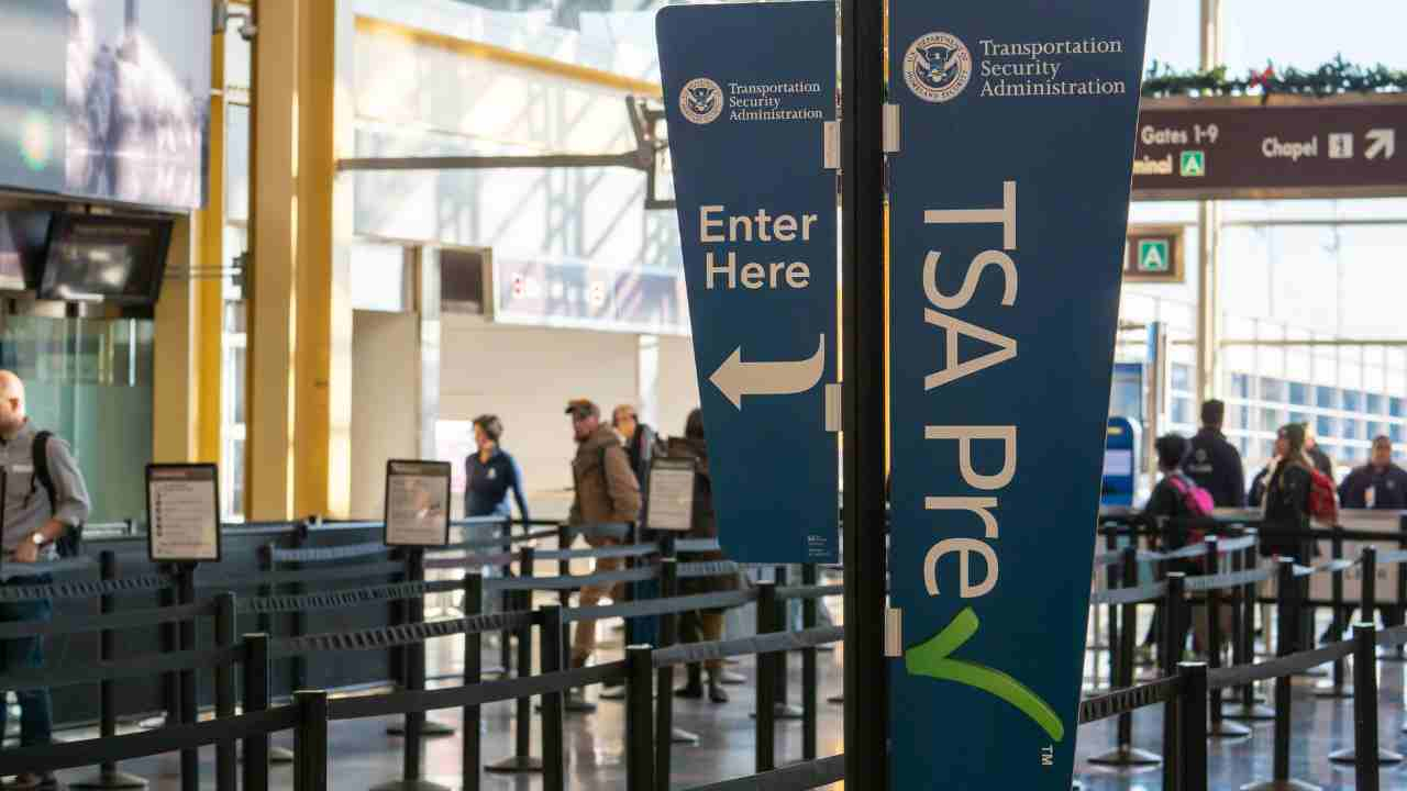 people are walking through an airport with a sign that says tsa precheck