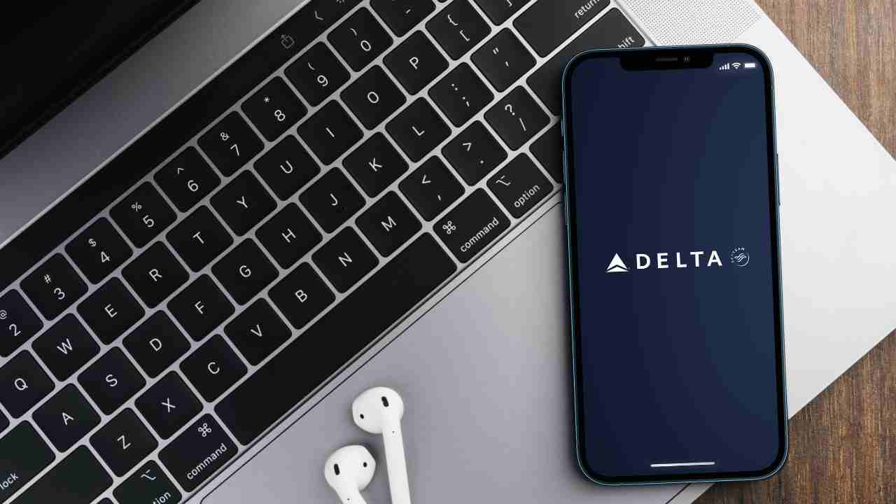 the delta app on an iPhone next to a laptop