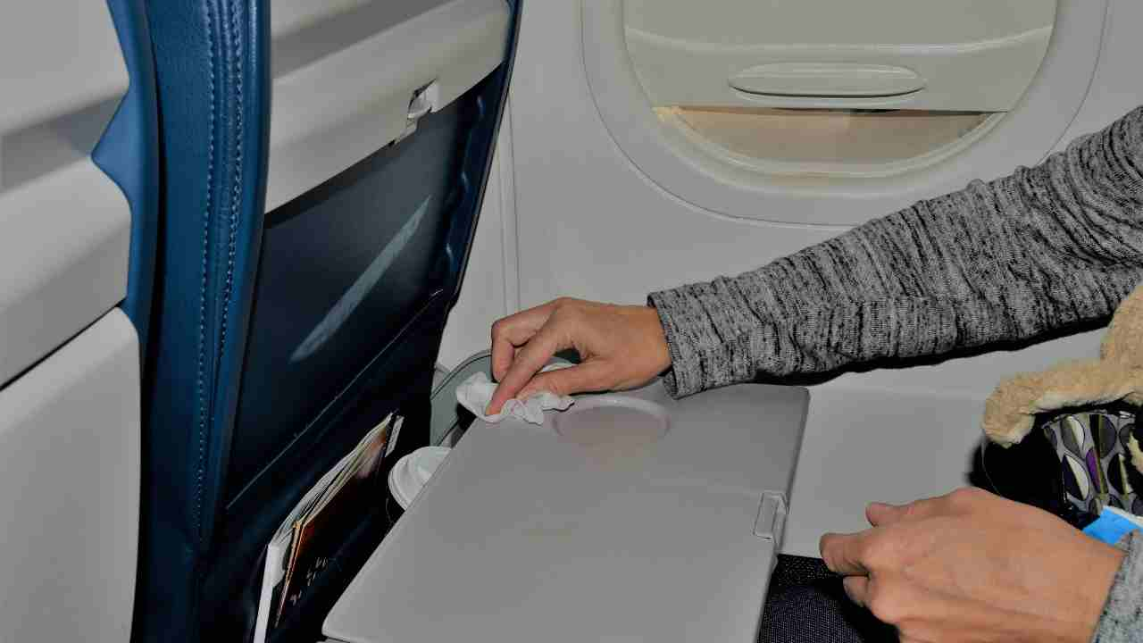 a person using an electronic device on an airplane