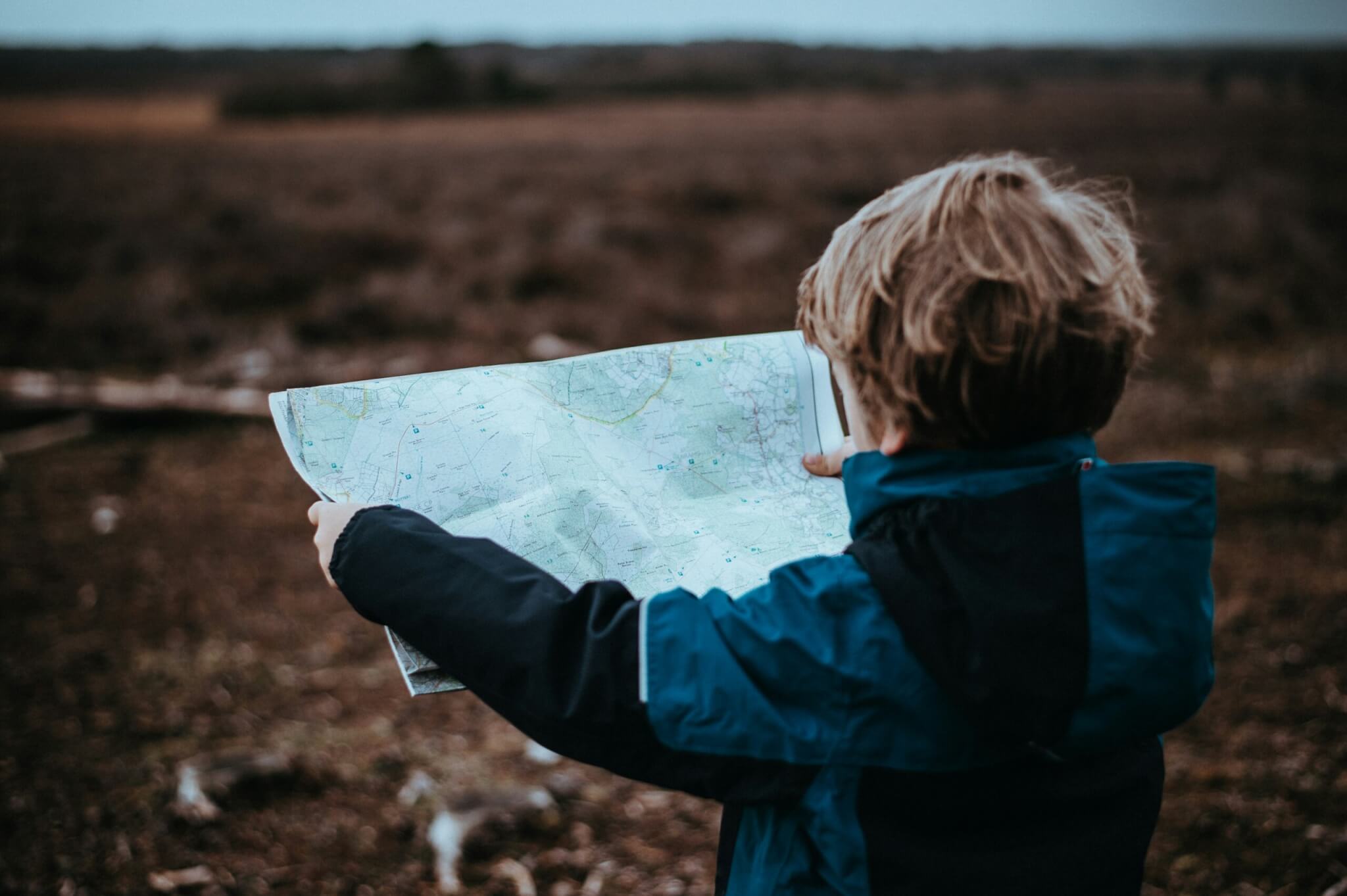 kid looking at a map