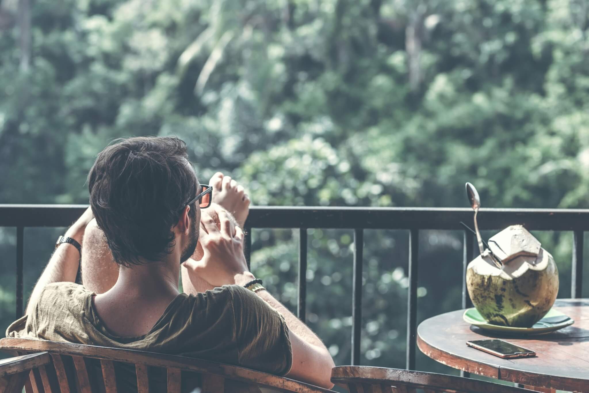 man sitting on a balcony