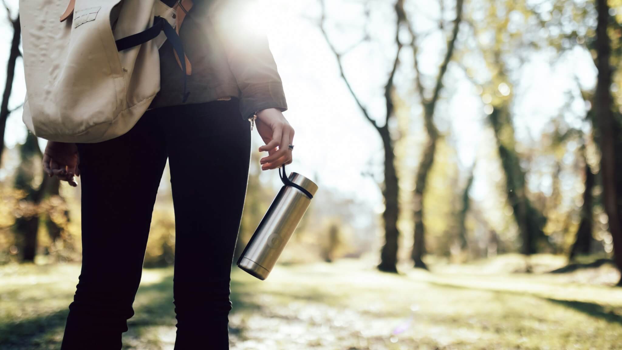 woman holding a reusable water bottle