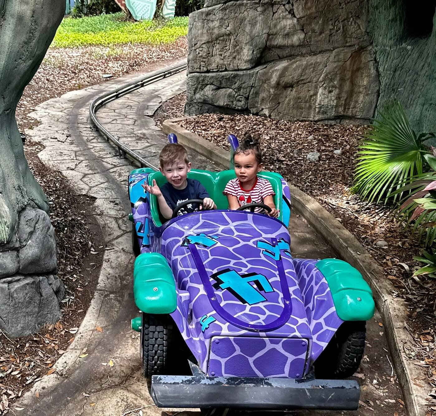 kids on ride at theme park