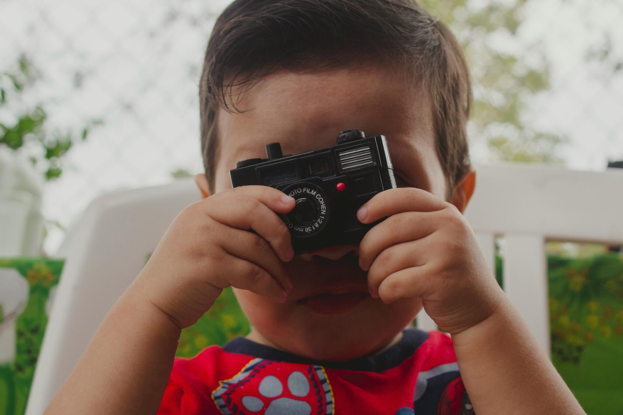 baby holding a camera