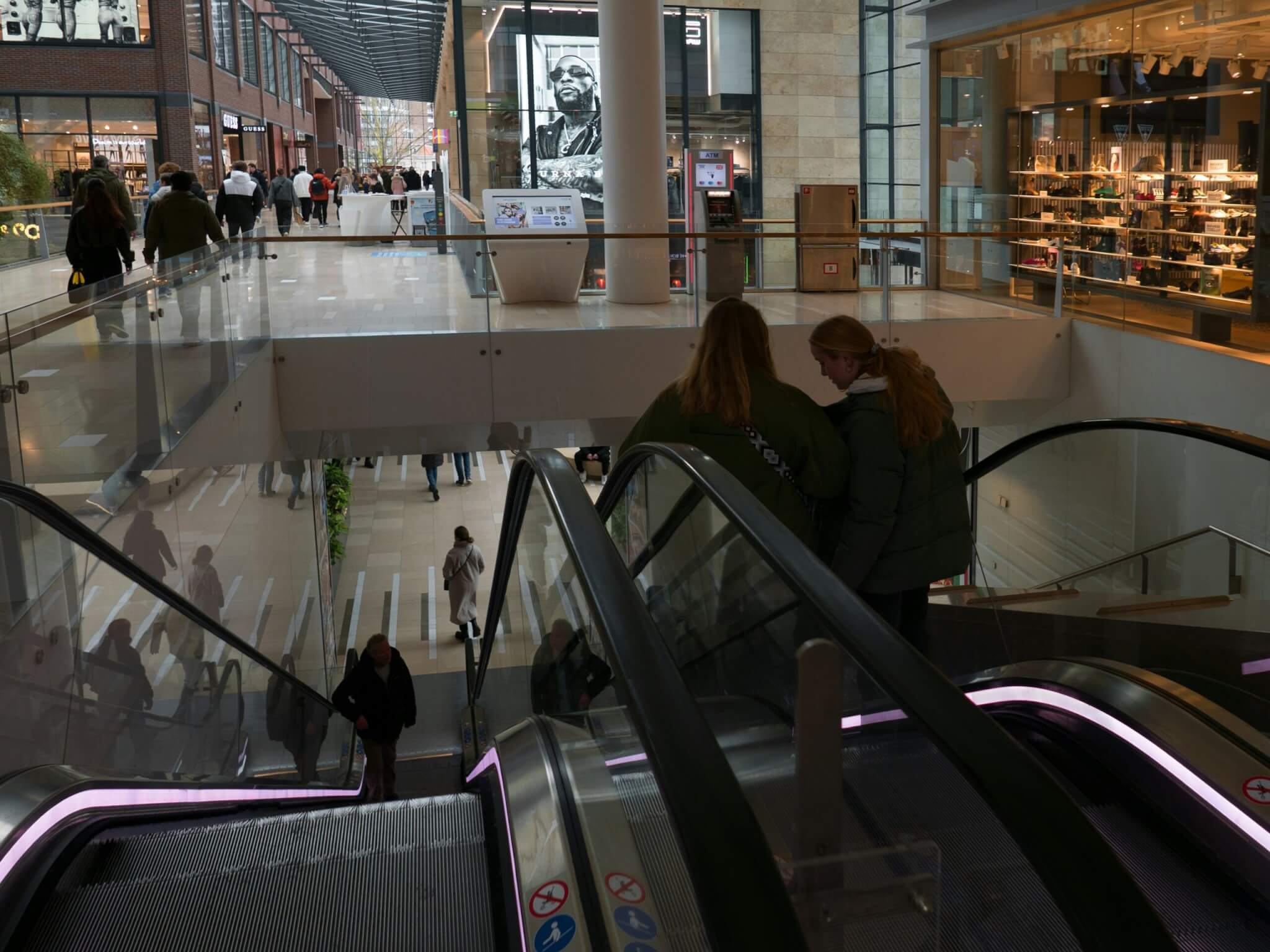 women riding an escalator