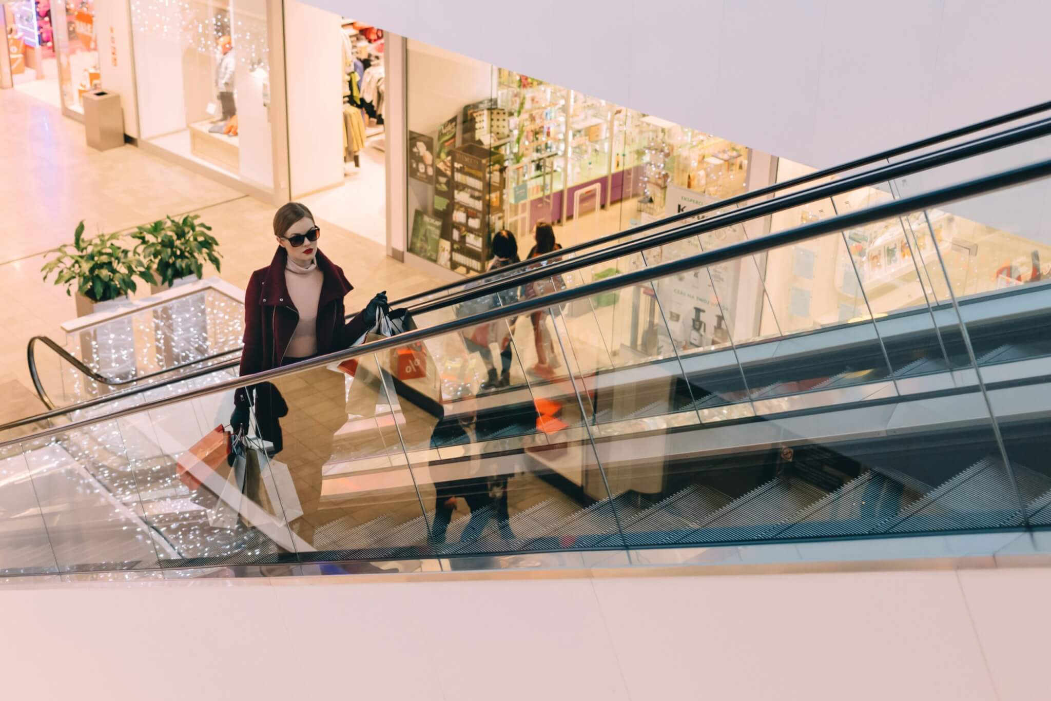 woman riding an escalator