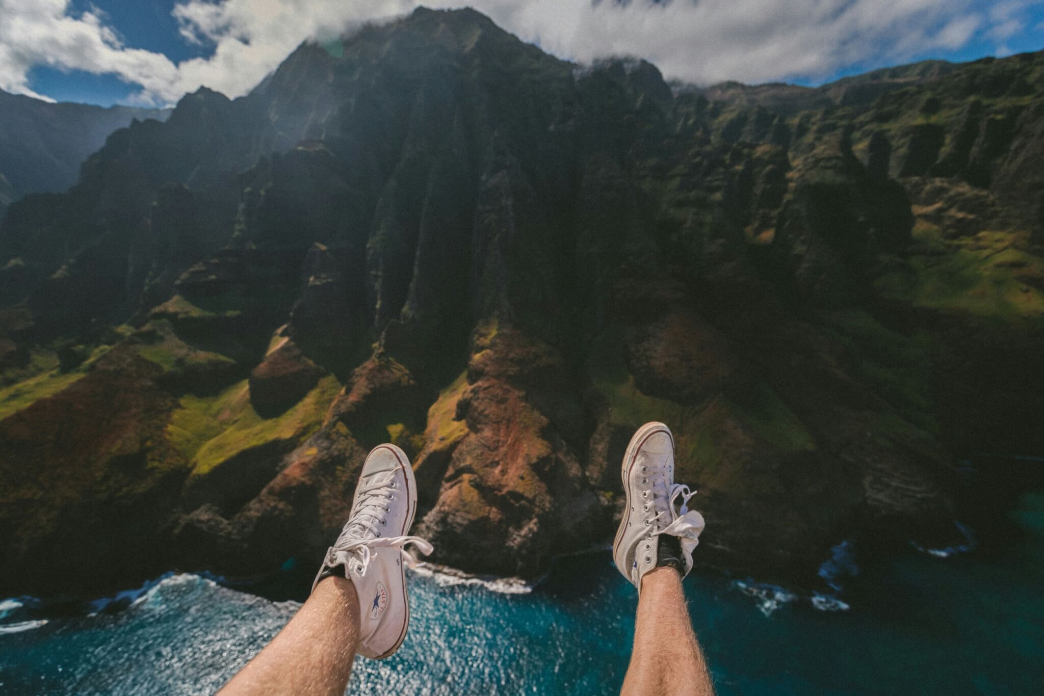 person sitting on a cliff