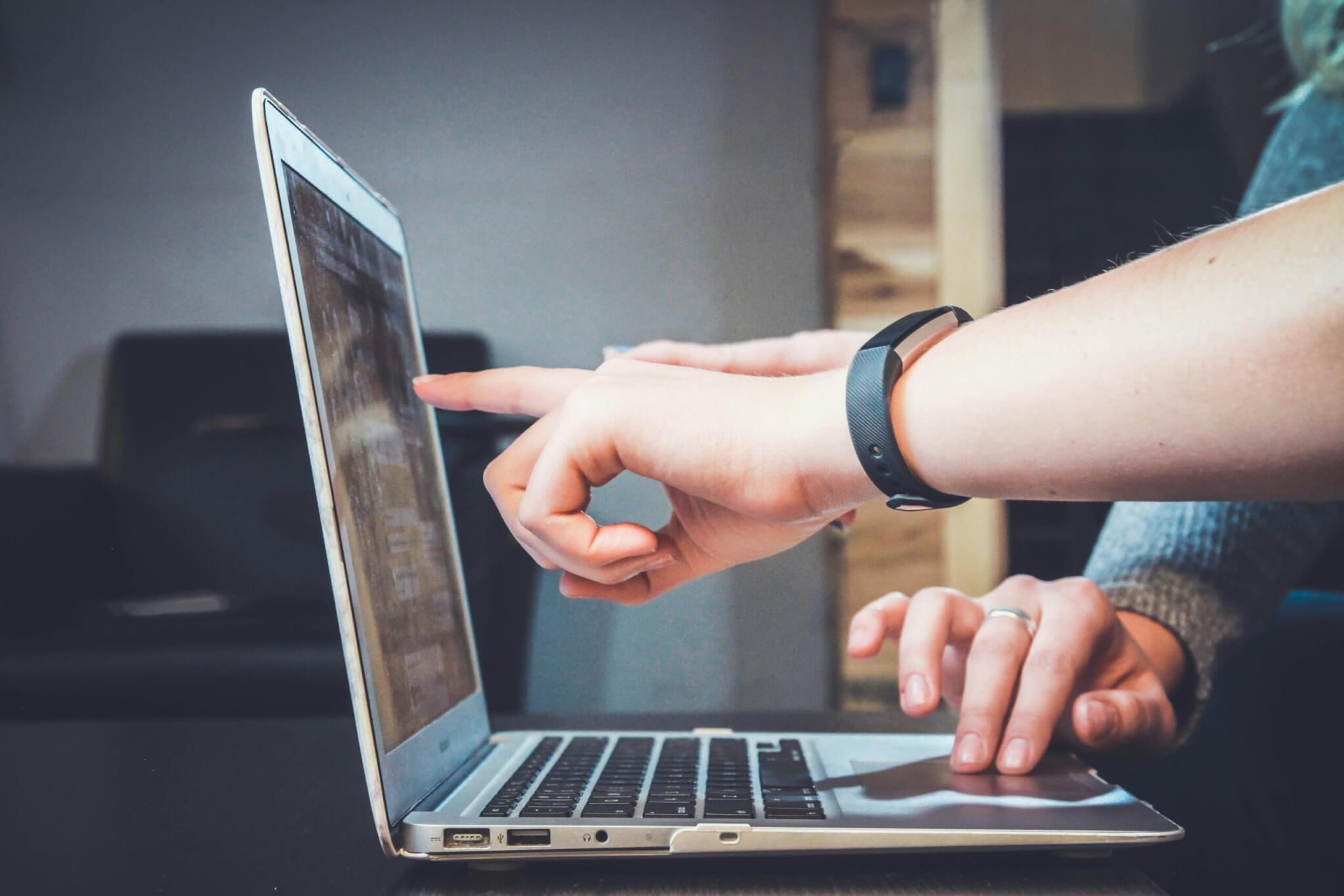 people pointing at a screen