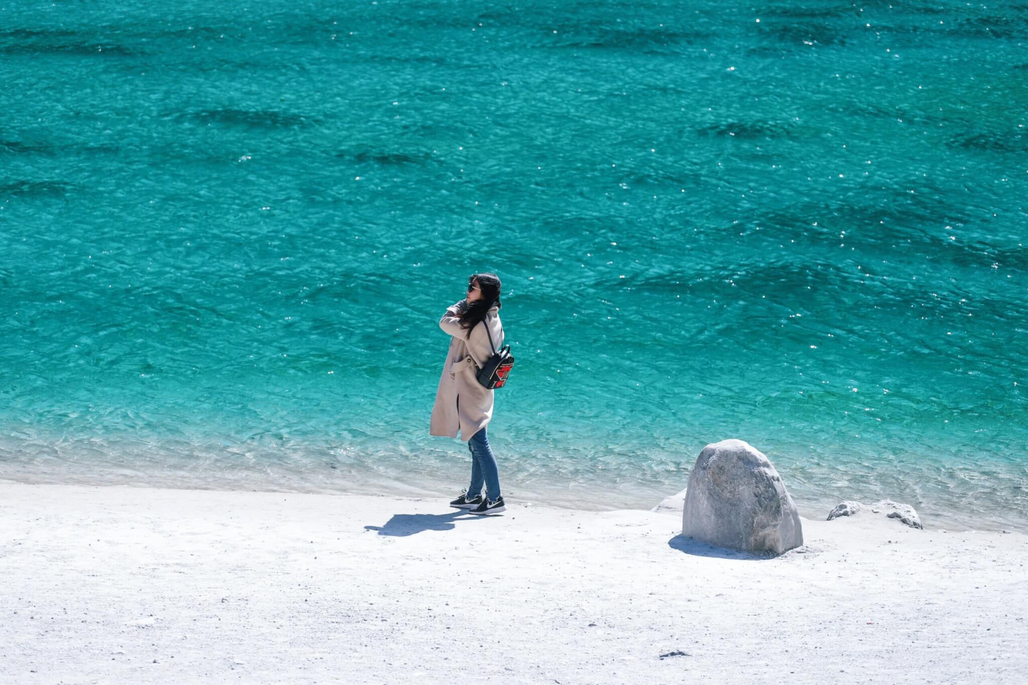 woman walking alone on beach