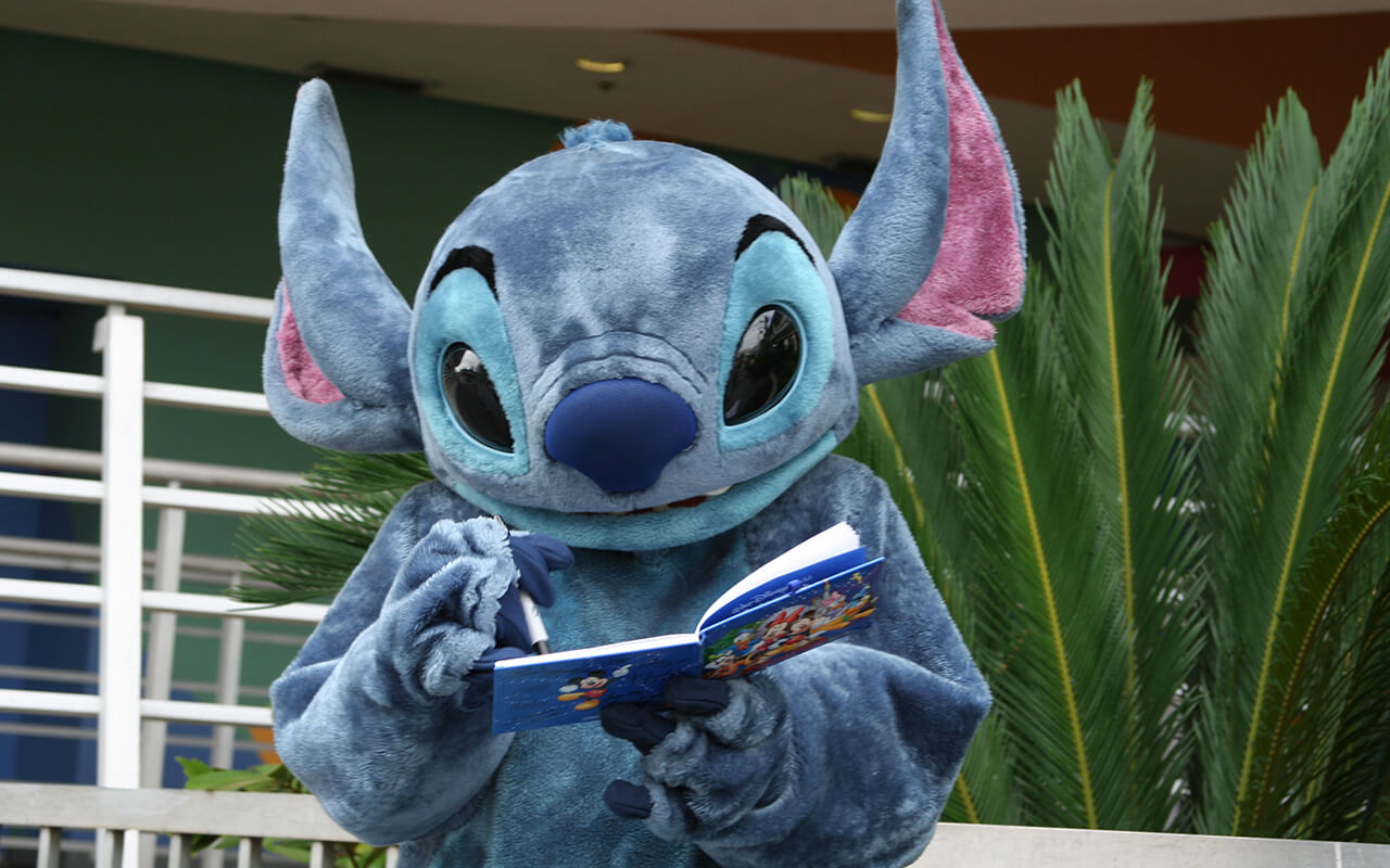 Disney character Stitch signing an autograph at Disney World