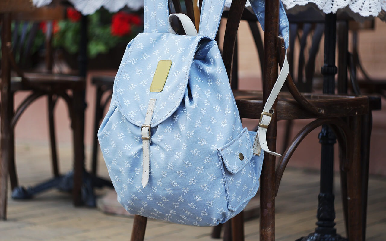 Backpack draped over back of a chair