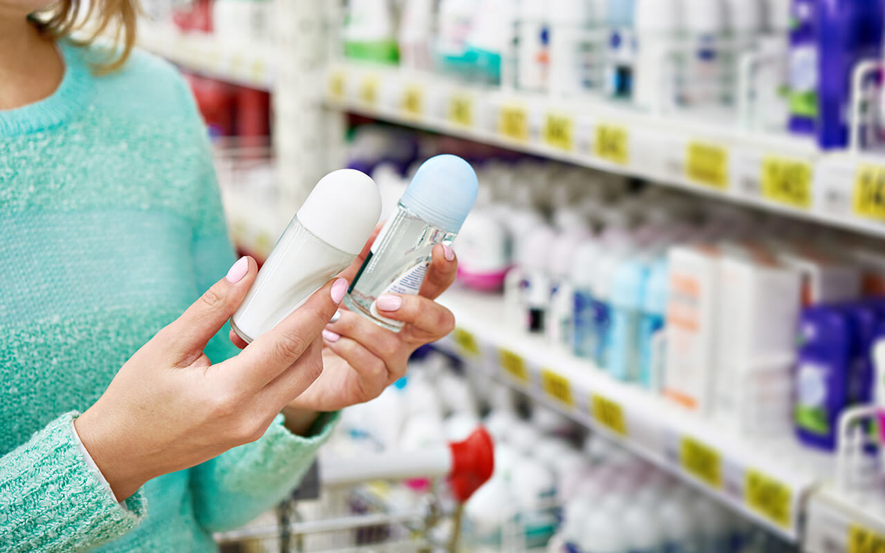 Woman choosing deodorant in a store