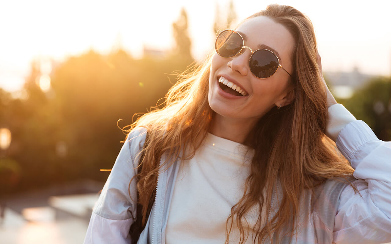 Woman wearing sunglasses and smiling