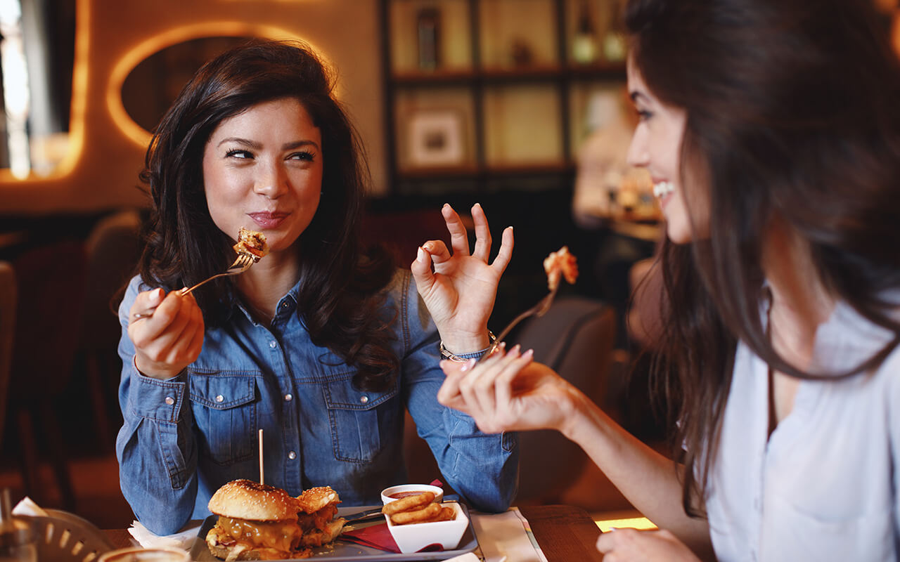 Woman eating a burger at a restaurant