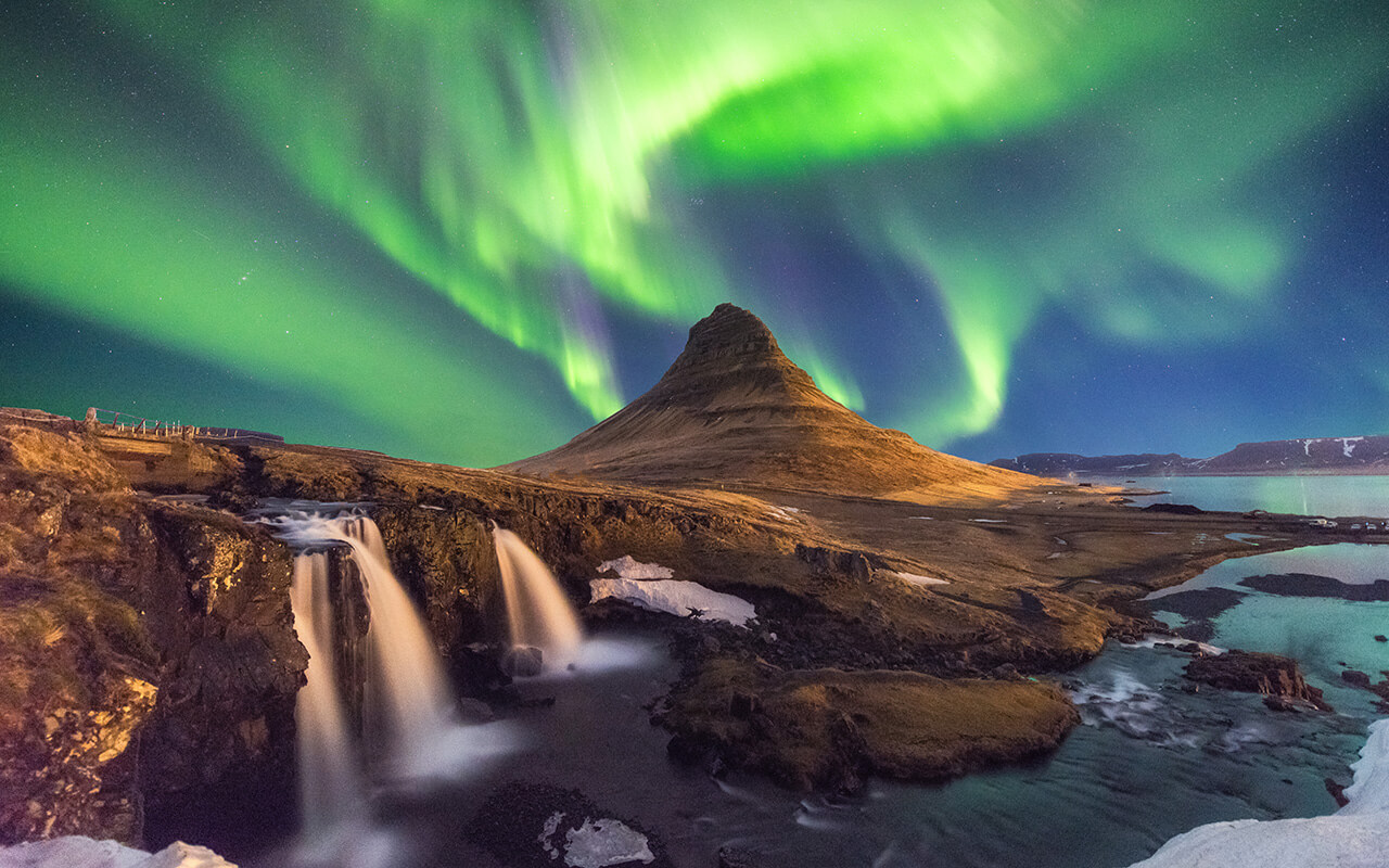 A wonderful night with Kp 5 . Northern lights mountain Kirkjufell in Iceland.