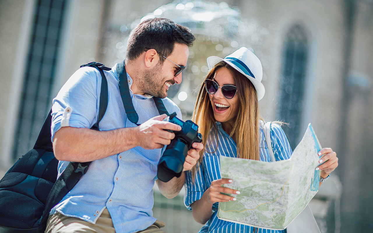 Man and woman looking at camera and map