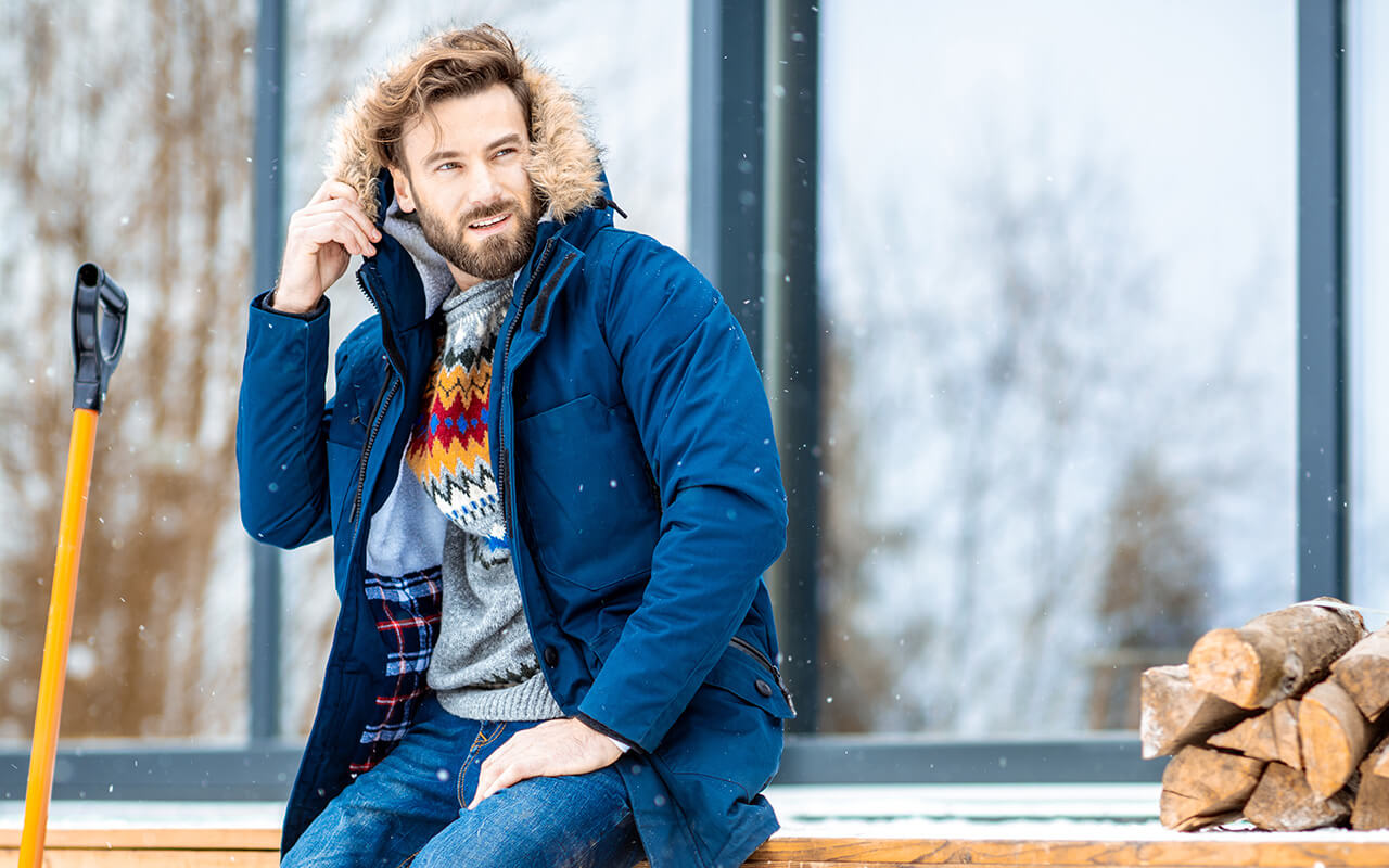 Man wearing a puffer coat in the snow